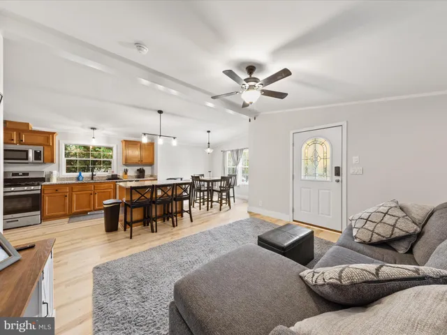 a living room with furniture and kitchen view
