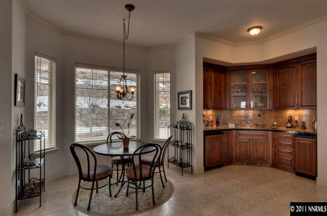 920 Schellbourne Road Reno, NV 89511 - Photo 5 of 13 a kitchen with stainless steel appliances granite countertop a stove top oven a sink dishwasher a dining table and chairs with wooden floor
