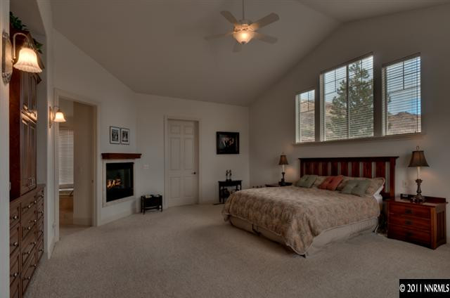 920 Schellbourne Road Reno, NV 89511 - Photo 7 of 13 a bedroom with a bed and a chandelier