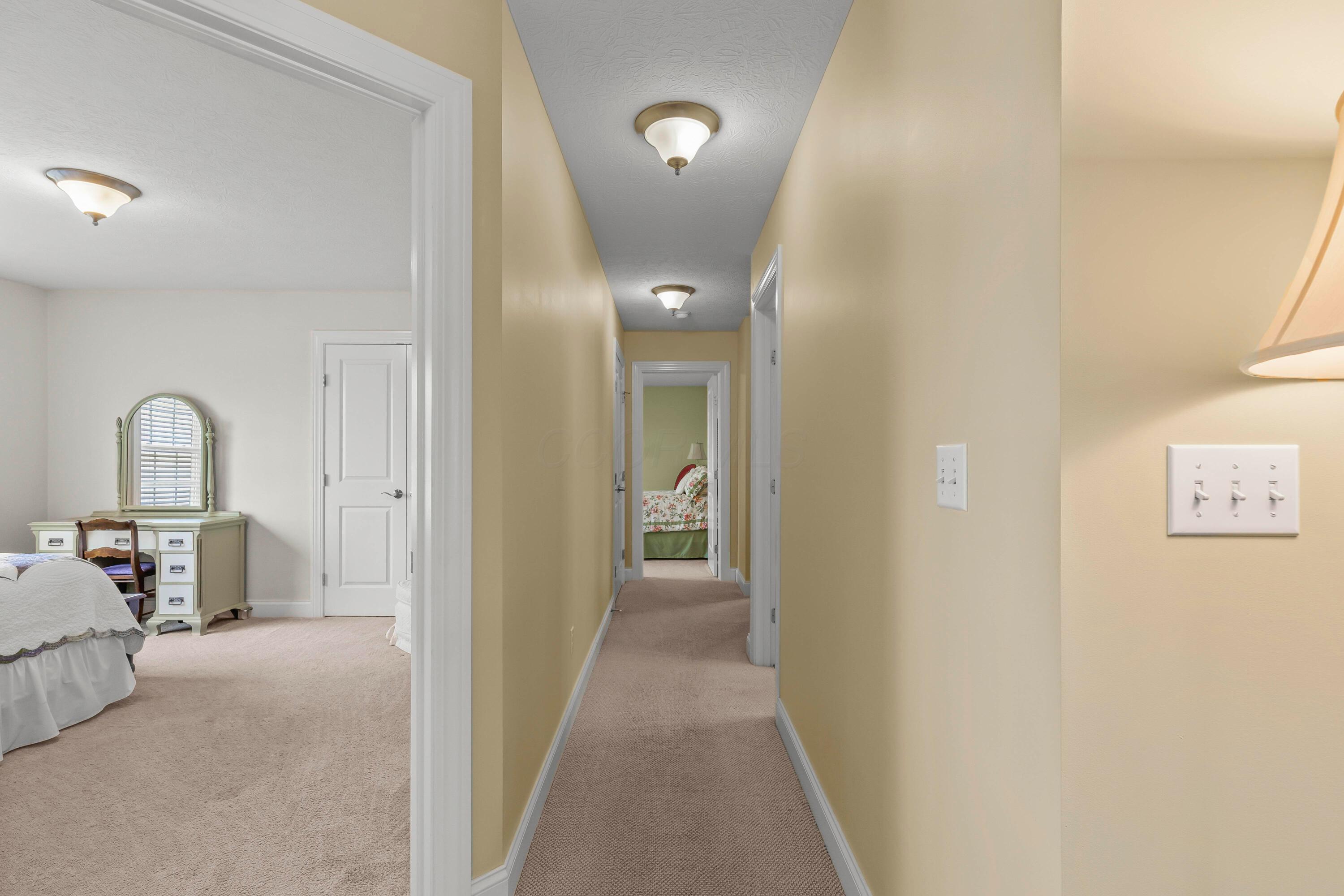 3582 Panhandle Road Delaware, OH 43015 - Photo 6 of 65 • Berber carpet • Vanilla painted walls • Ceiling light • Hall linen closet • Attic access