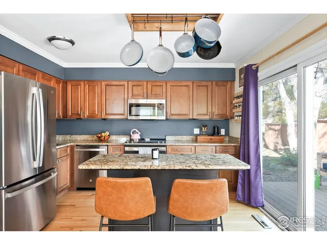 a kitchen with stainless steel appliances granite countertop a sink and a stove