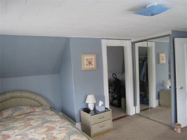 74 Madison Avenue Everett, MA 02149 - Photo 11 of 28 a bedroom with a bed and a mirror
