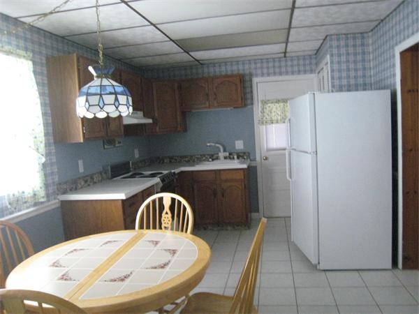 74 Madison Avenue Everett, MA 02149 - Photo 17 of 28 a kitchen with refrigerator and window