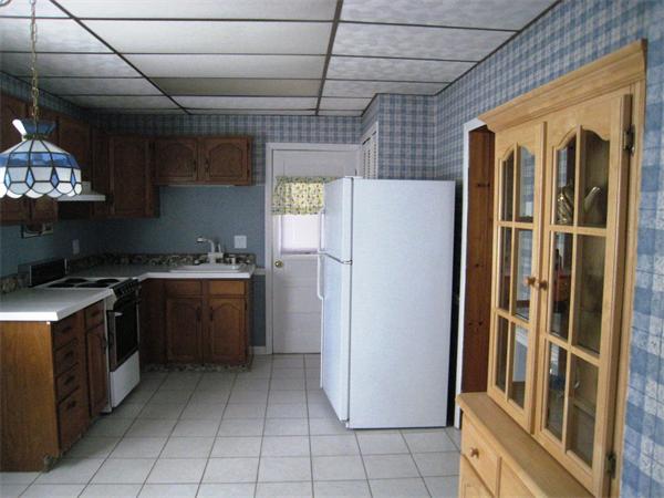 74 Madison Avenue Everett, MA 02149 - Photo 18 of 28 a kitchen with a refrigerator and a sink