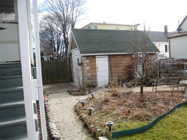 74 Madison Avenue Everett, MA 02149 - Photo 23 of 28 a view of a house with a small yard and wooden fence