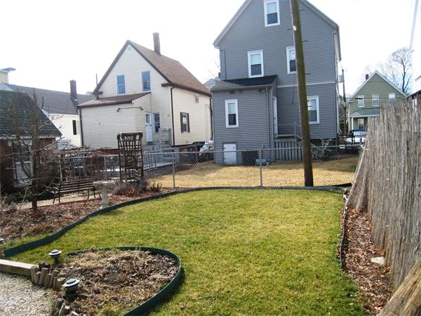 74 Madison Avenue Everett, MA 02149 - Photo 25 of 28 a view of a house with swimming pool and a yard