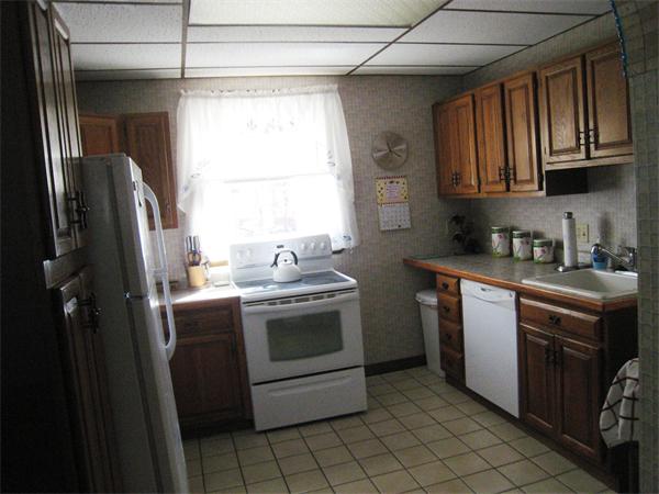 74 Madison Avenue Everett, MA 02149 - Photo 4 of 28 a kitchen with stainless steel appliances granite countertop a stove a sink and a refrigerator