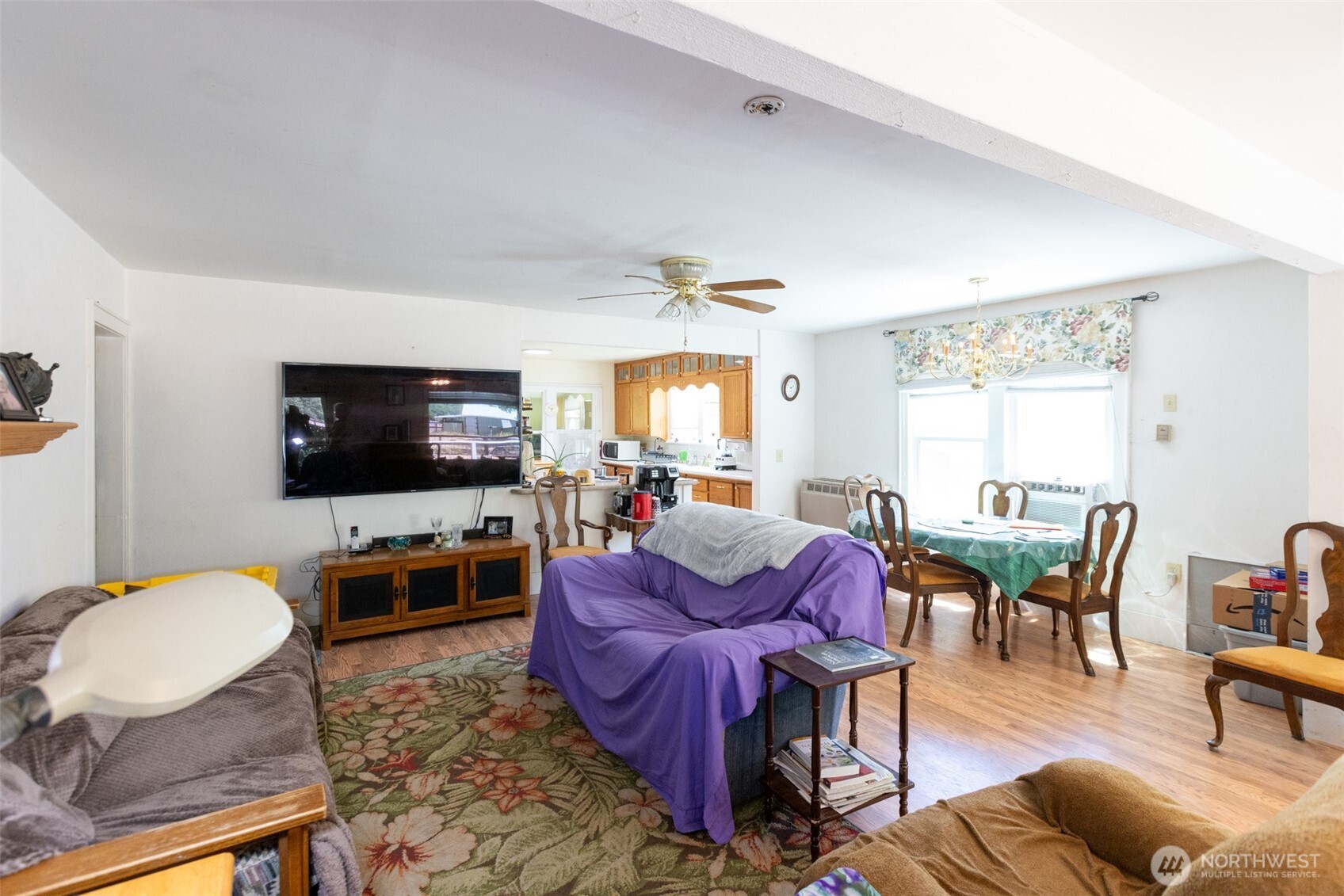 992 Highway 142 Lyle, WA 98635 - Photo 12 of 40 a living room with furniture a flat screen tv and a window