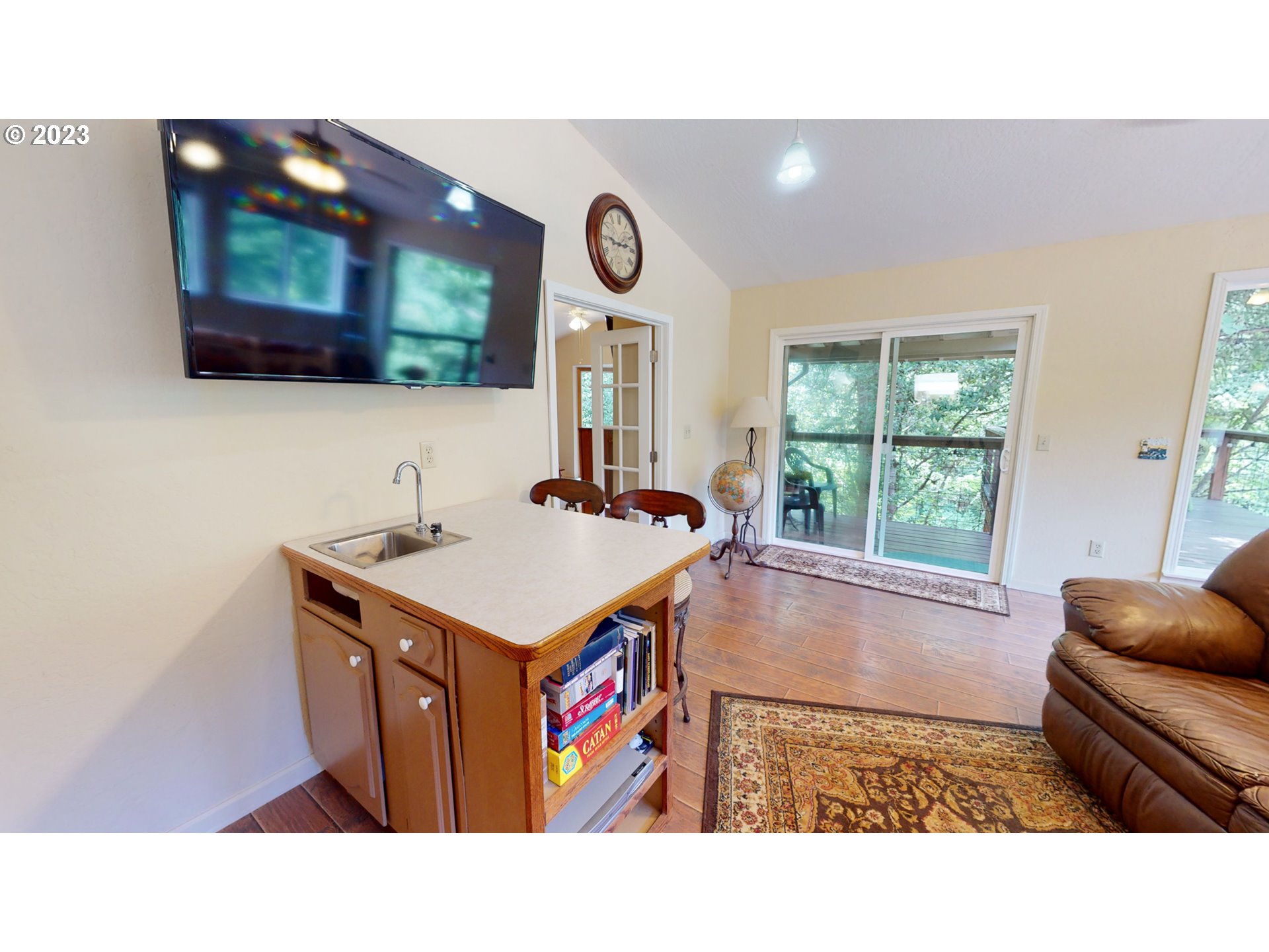 13141 Driver Valley Road Oakland, OR 97462 - Photo 24 of 48 a kitchen with a stove a refrigerator and a fireplace with wooden floor