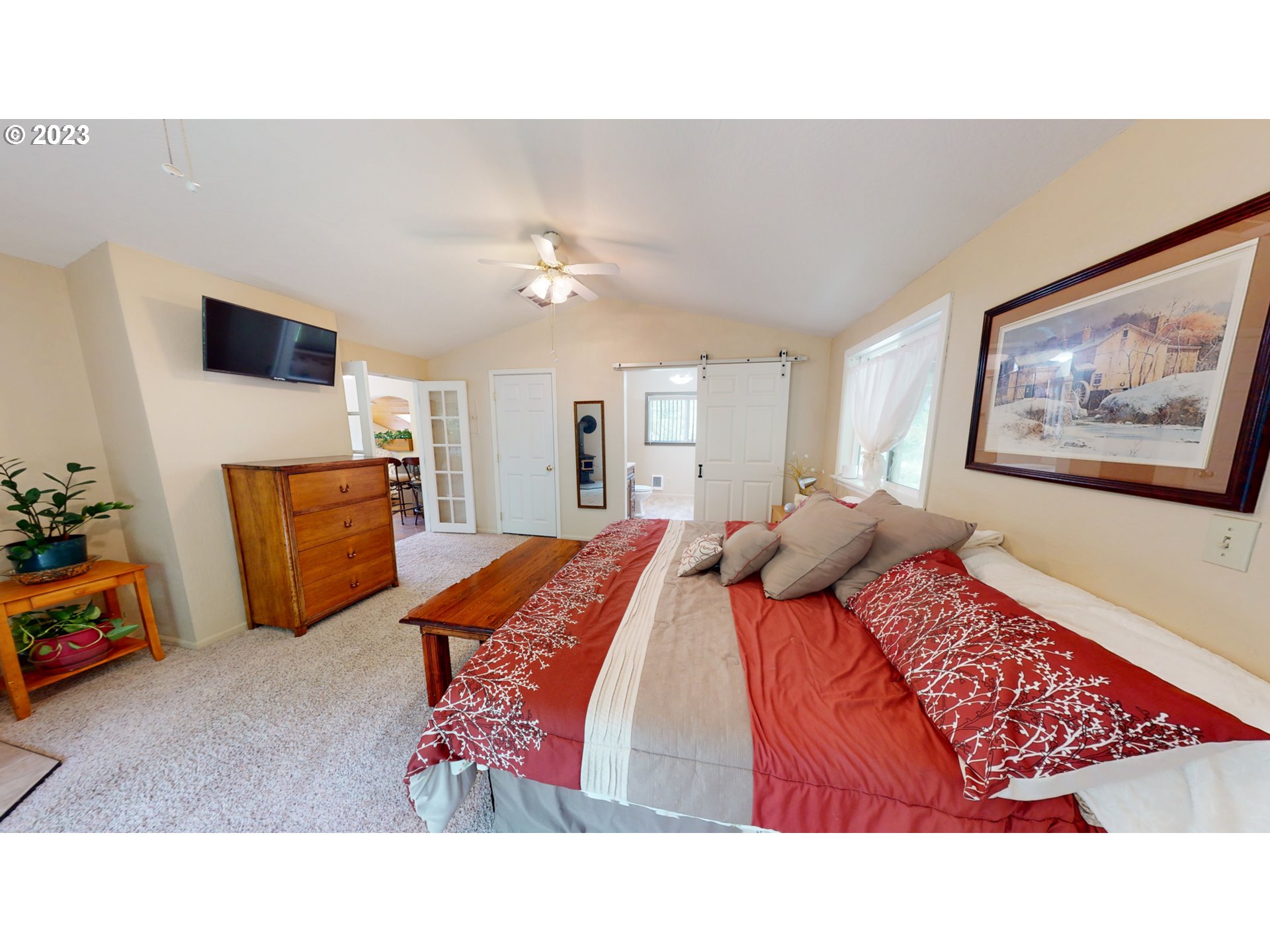 13141 Driver Valley Road Oakland, OR 97462 - Photo 27 of 48 a bedroom with a bed and a chandelier