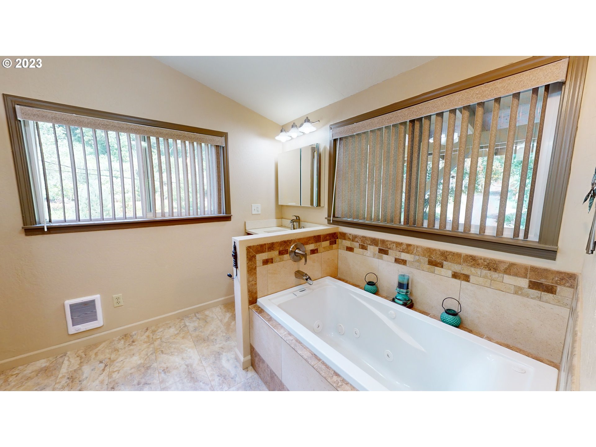 13141 Driver Valley Road Oakland, OR 97462 - Photo 29 of 48 a bathroom with a tub a sink and a window