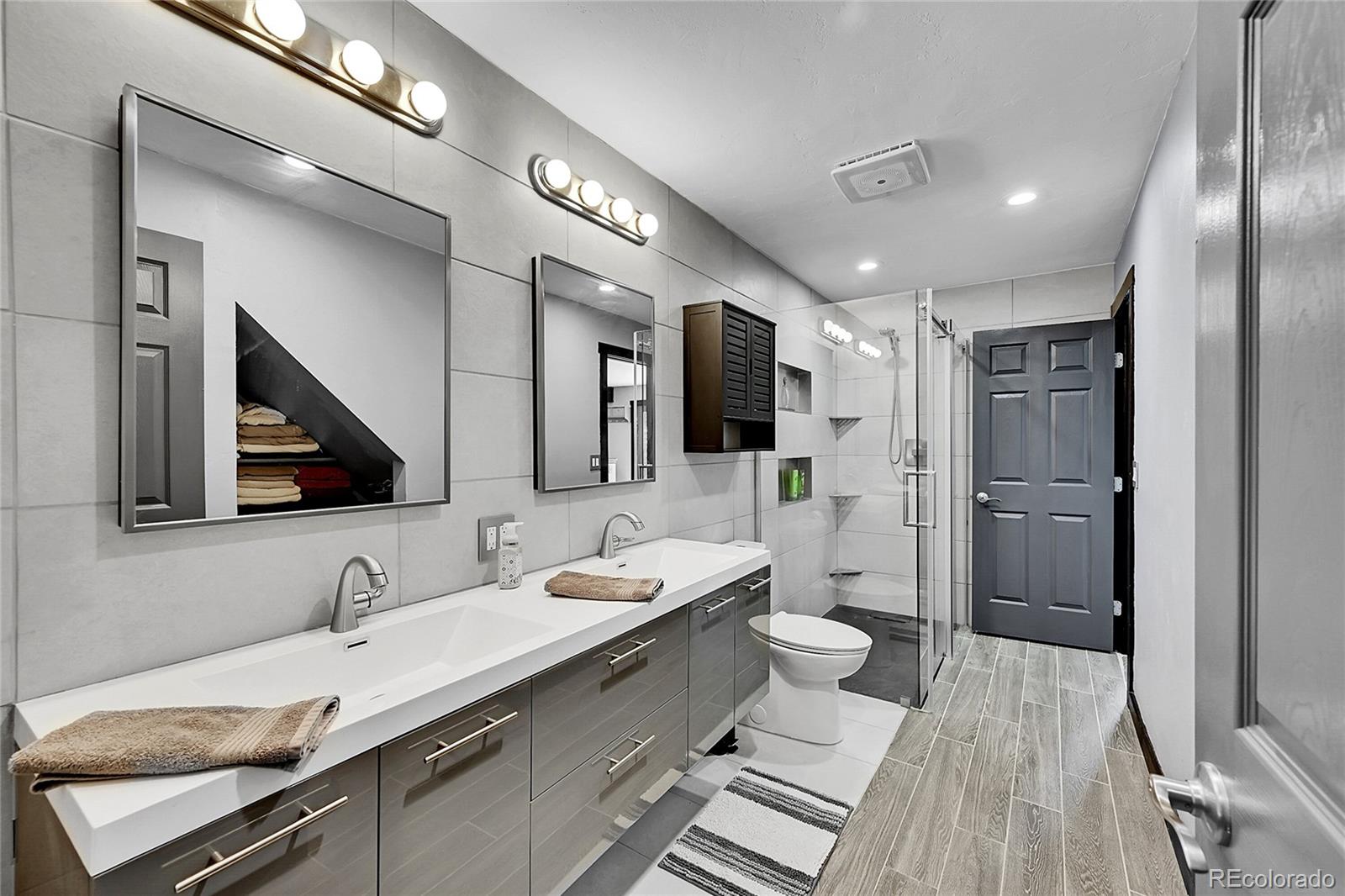 1424 Sheep Ridge Road Fairplay, CO 80440 - Photo 20 of 47 a bathroom with a double vanity sink a mirror and toilet