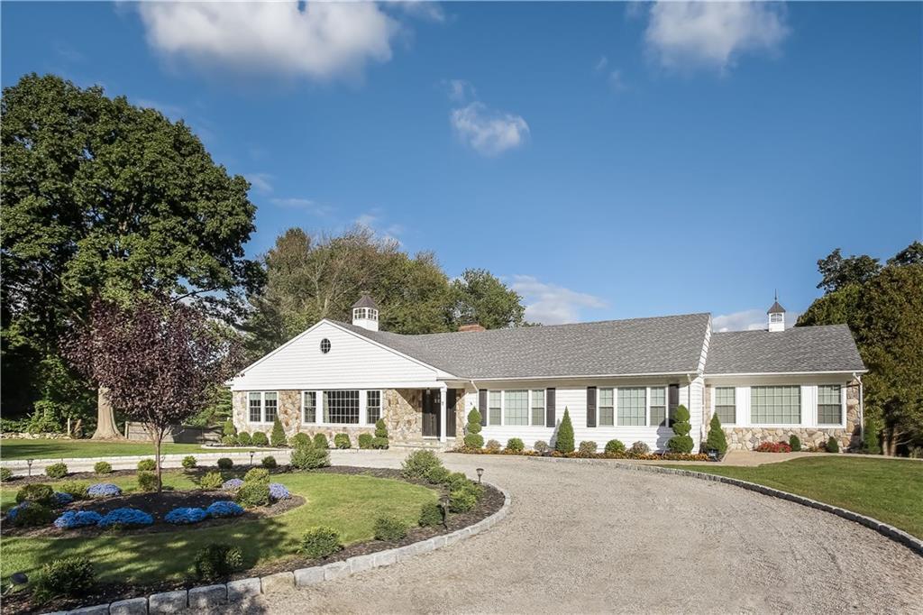 7 Hartcroft Road Stamford, CT 06903 - Photo 1 of 1 a front view of a house with a garden
