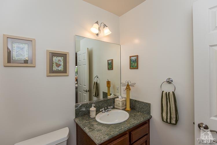 681 Rancho Road Thousand Oaks, CA 91362 - Photo 22 of 45 a bathroom with a granite countertop sink and a mirror