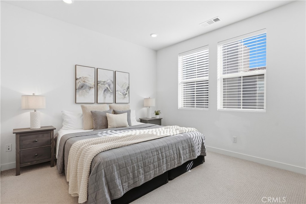 1300 Lasso Way, Unit 305 Rancho Mission Viejo, CA 92694 - Photo 14 of 75 a bedroom with a bed a dresser and a window