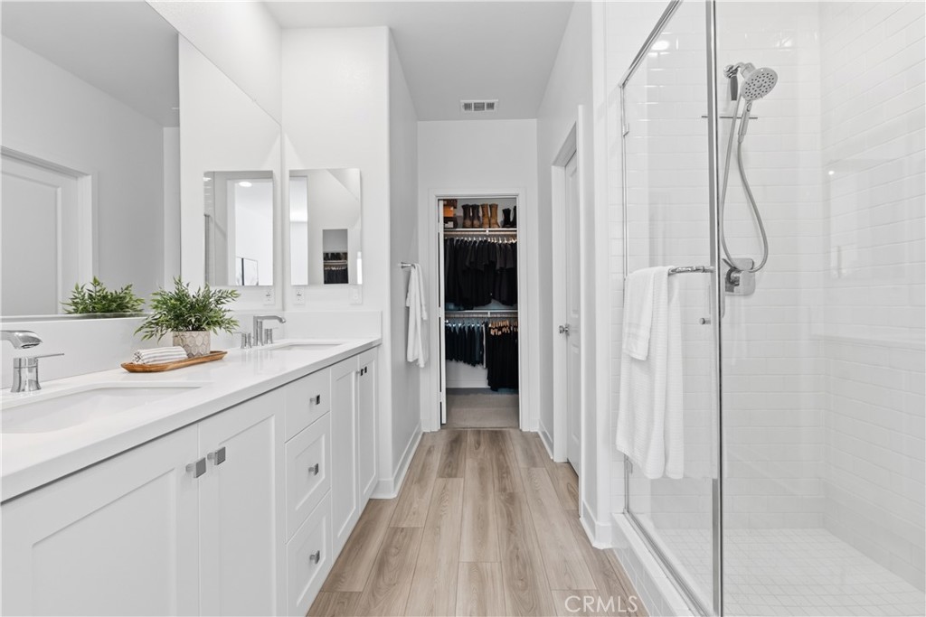 1300 Lasso Way, Unit 305 Rancho Mission Viejo, CA 92694 - Photo 17 of 75 a spacious bathroom with a double vanity sink and a mirror