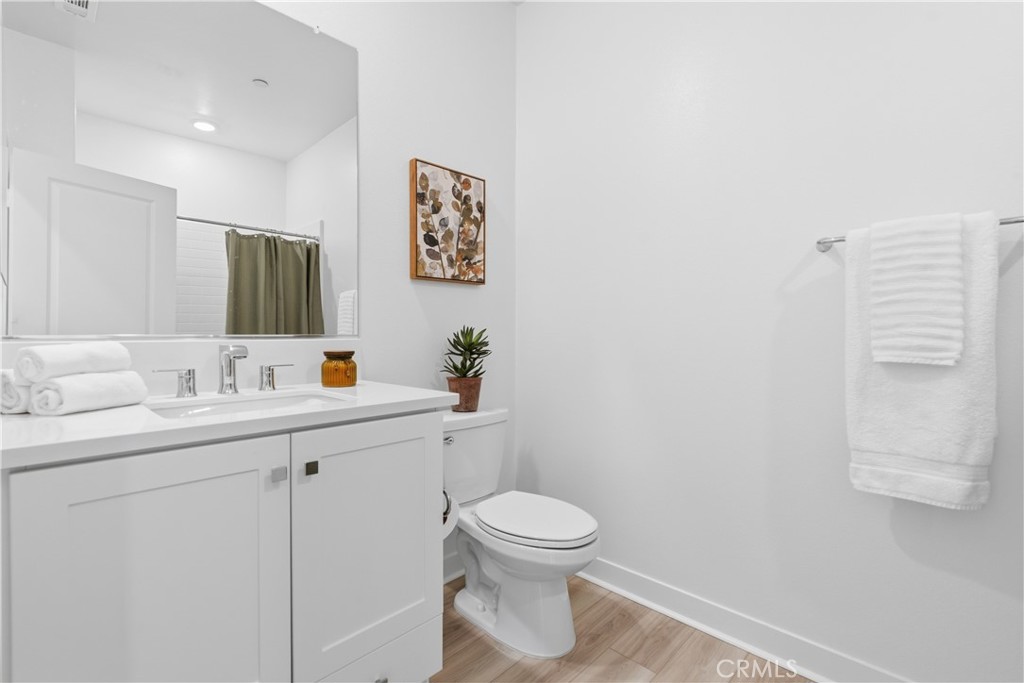 1300 Lasso Way, Unit 305 Rancho Mission Viejo, CA 92694 - Photo 24 of 75 a bathroom with a toilet a sink and mirror