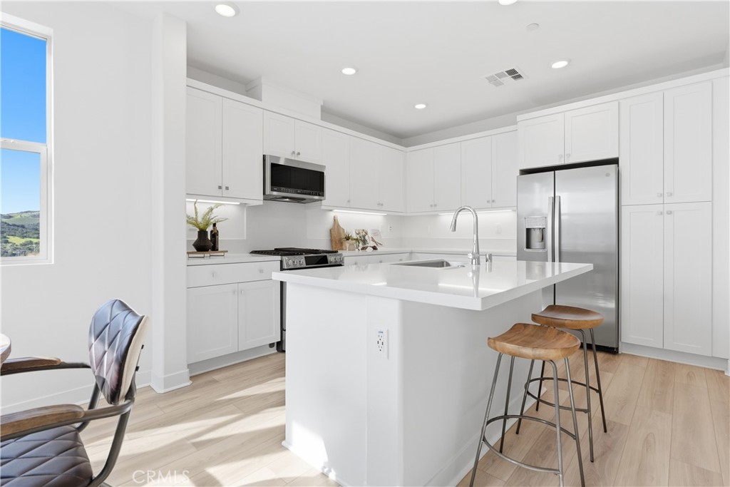 1300 Lasso Way, Unit 305 Rancho Mission Viejo, CA 92694 - Photo 4 of 75 a kitchen with a table and chairs