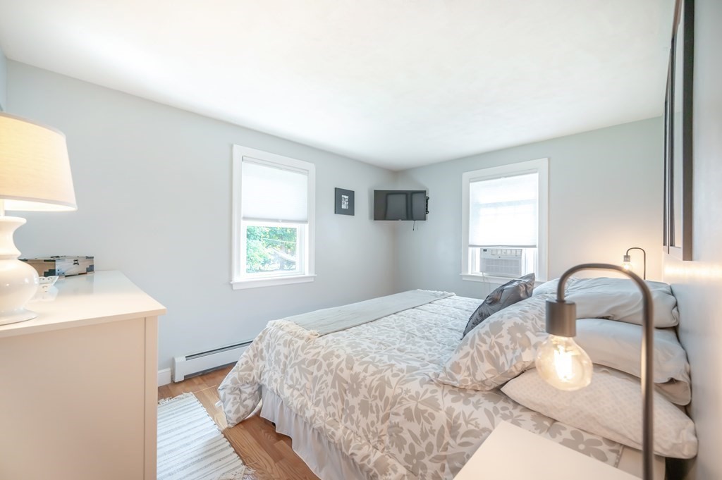 15 Anna Road Woburn, MA 01801 - Photo 16 of 28 a bedroom with a bed and a sink with wooden floor