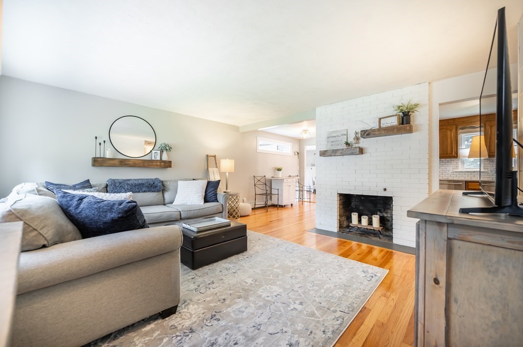 15 Anna Road Woburn, MA 01801 - Photo 7 of 28 a living room with furniture and a fireplace