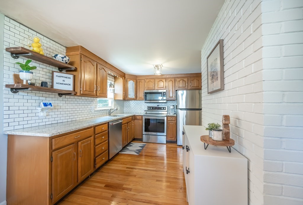 15 Anna Road Woburn, MA 01801 - Photo 10 of 28 a kitchen with stainless steel appliances granite countertop a sink and cabinets
