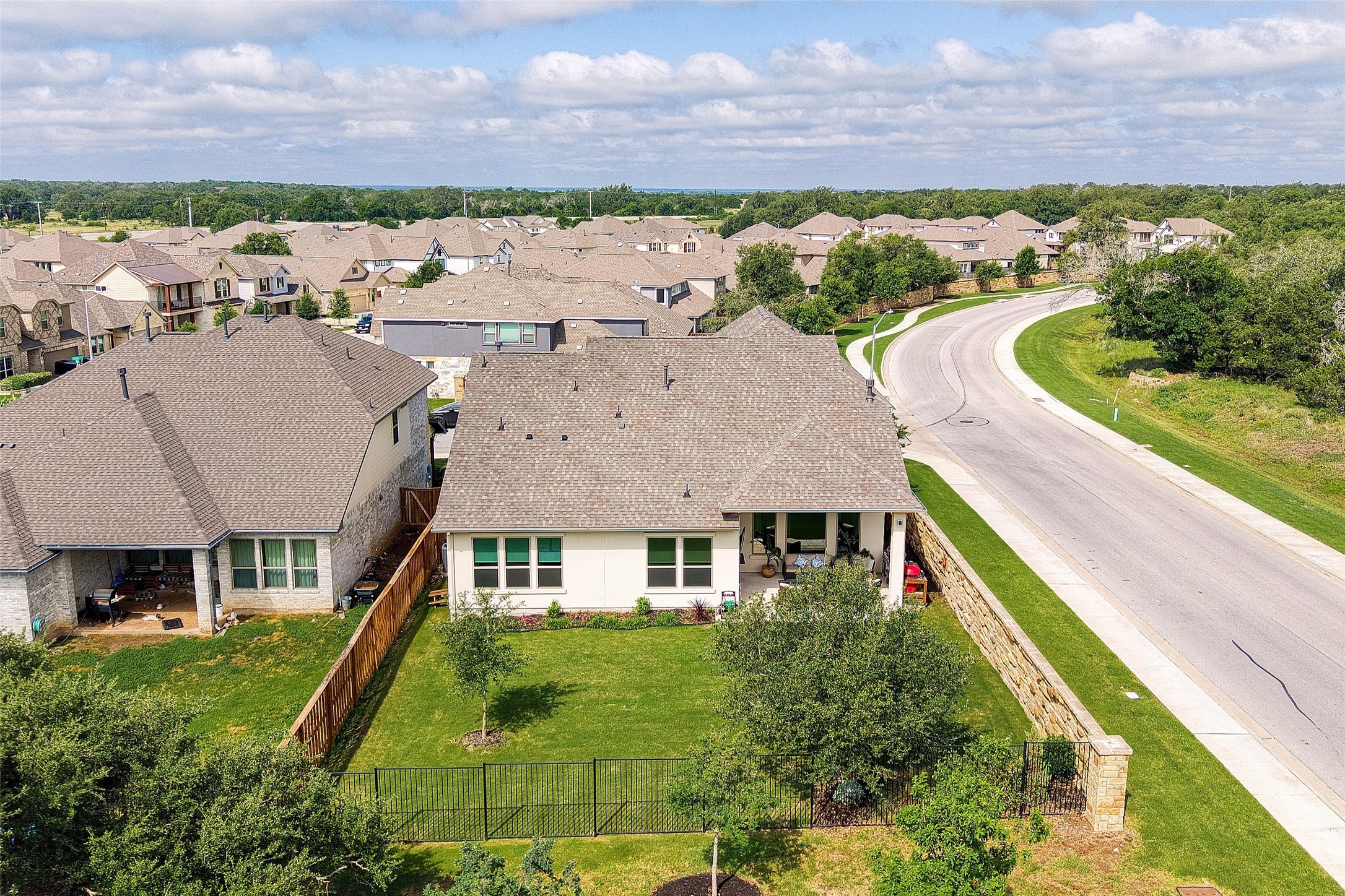 2408 Nate's Place Georgetown, TX 78633 - Photo 33 of 40 An aerial perspective reveals a vibrant neighborhood with verdant lawns and varied home designs.