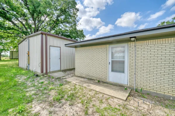 a view of a backyard with brick wall