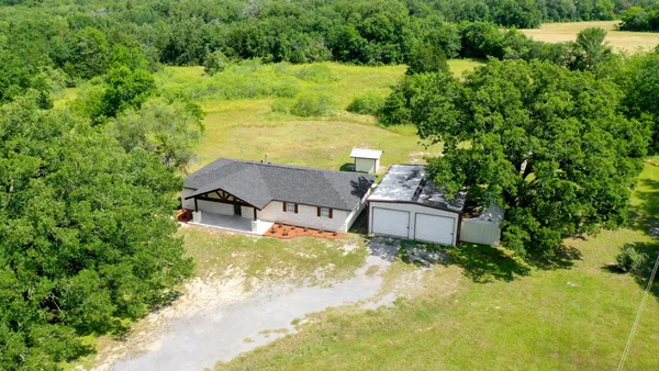an aerial view of a house with yard swimming pool and outdoor seating