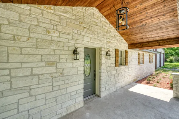 a view of a brick house with many windows