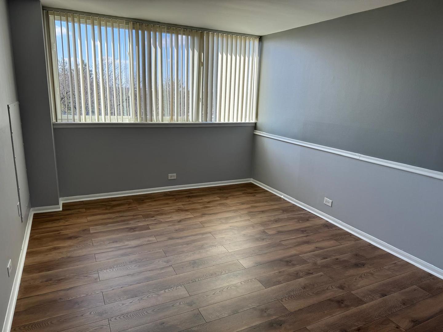 101 Bar Harbour Road, Unit 6A Schaumburg, IL 60193 - Photo 27 of 32 a view of an empty room with wooden floor and a window