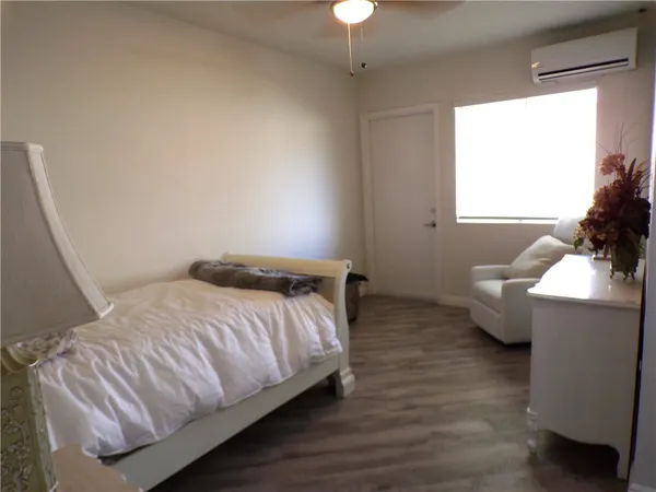 a bedroom with a bed and window
