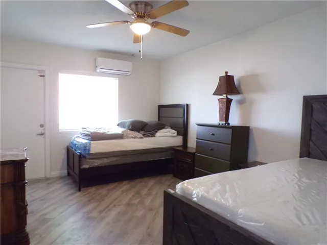 a bedroom with bed and a chandelier