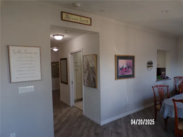 a view of a hallway to a livingroom with furniture and a hallway