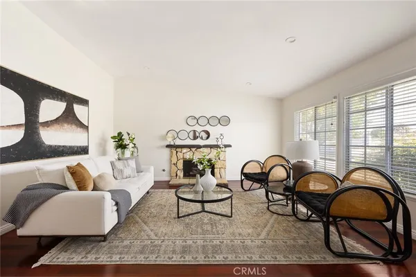 a living room with furniture a rug and window