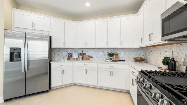 a kitchen with a dining table chairs and view kitchen