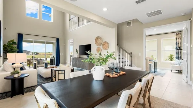 a living room with fireplace furniture and a large window