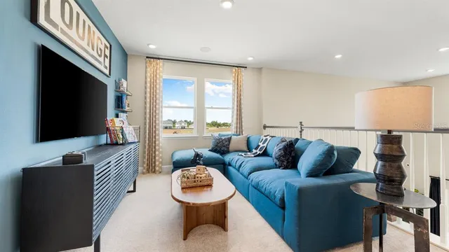 a view of a living room and hall way with furniture