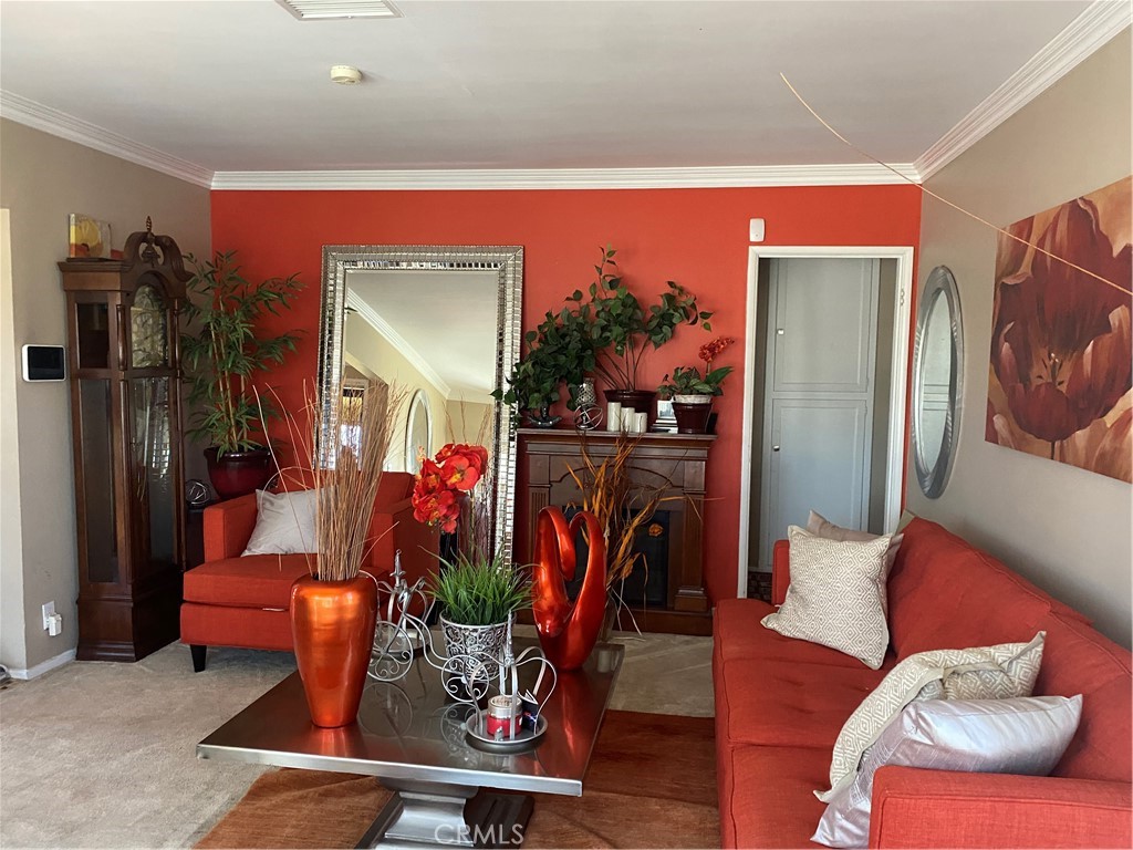 2737 West Caldwell Street Compton, CA 90220 - Photo 4 of 12 a living room with furniture a flat screen tv and a large window