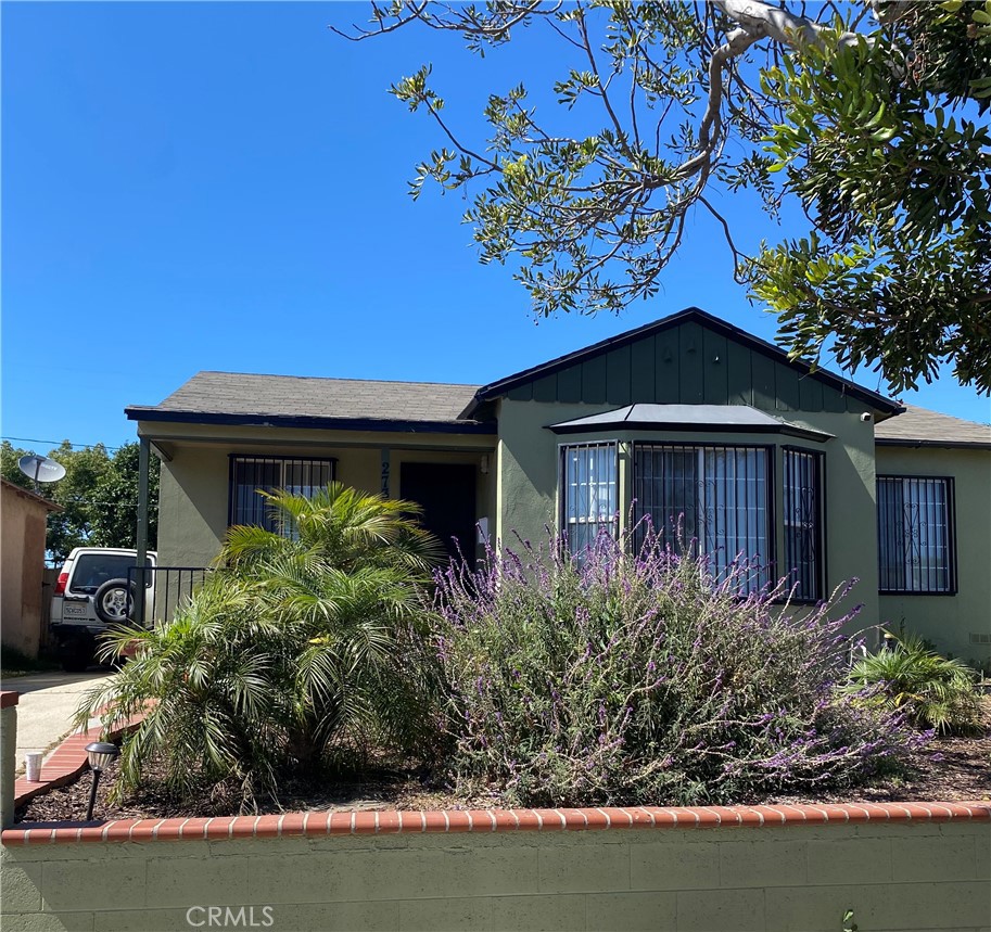 2737 West Caldwell Street Compton, CA 90220 - Photo 7 of 12 a front view of a house with garden