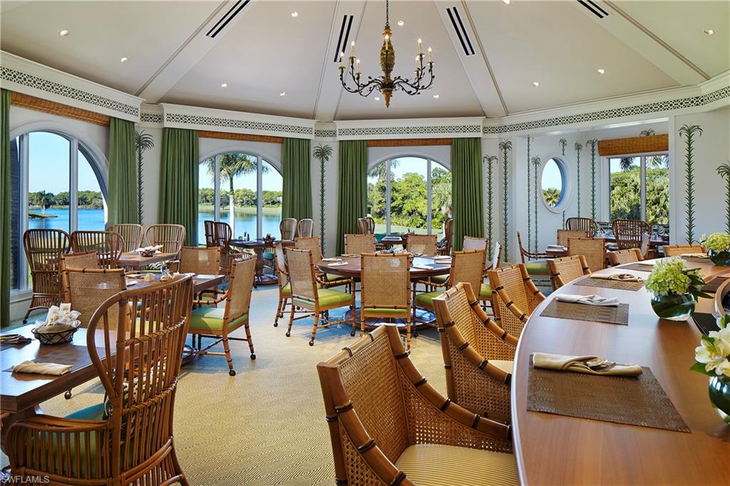 258 Audubon Boulevard Naples, FL 34110 - Photo 20 of 30 a living room with furniture a large window and potted plants