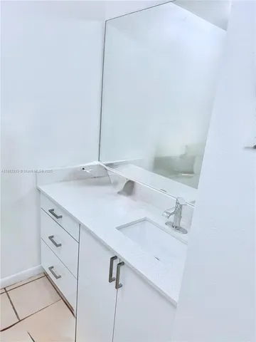 a bedroom with a bed and a lamp with wooden floor