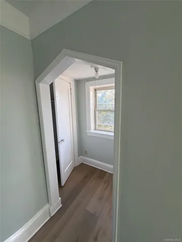 an entryway view with wooden floor and staircase