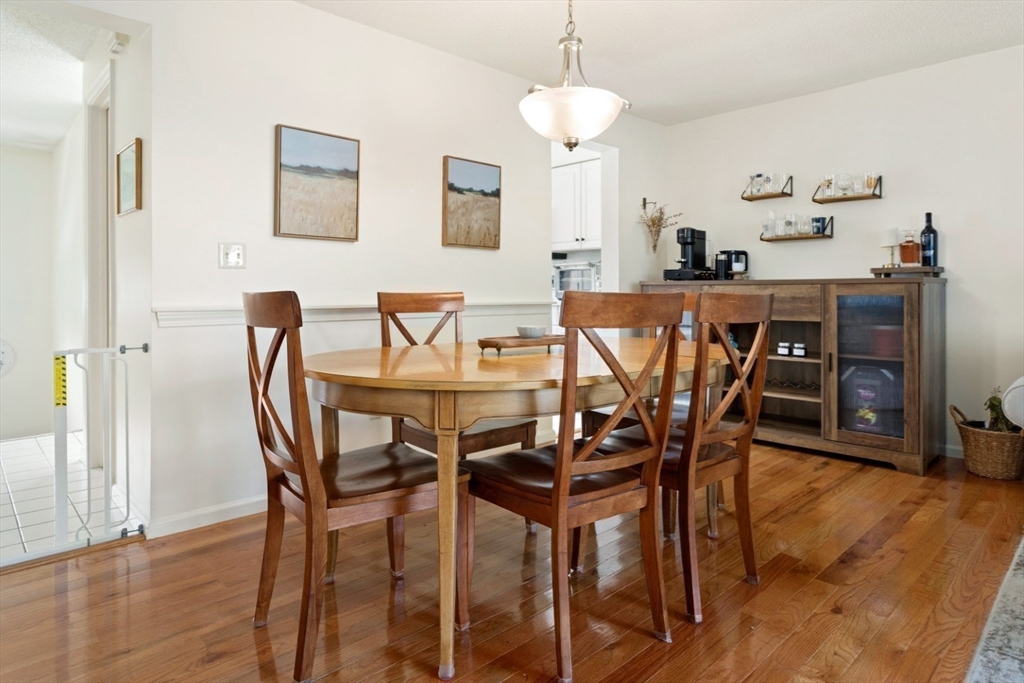 108 Abington Road, Unit 108 Danvers, MA 01923 - Photo 13 of 34 a view of a dining room with furniture and wooden floor