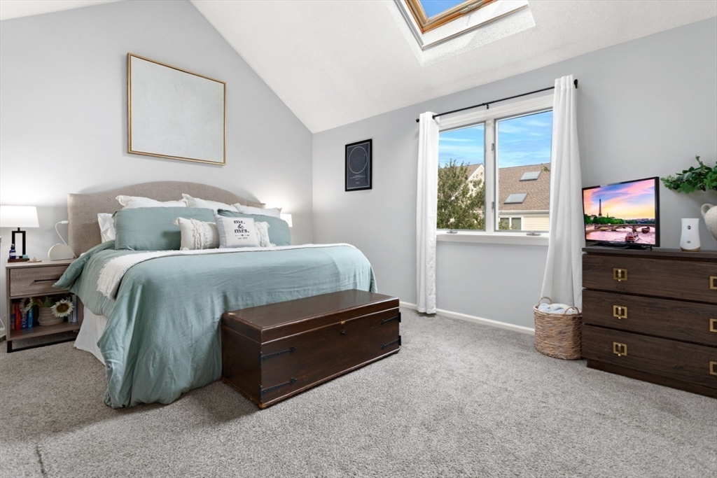 108 Abington Road, Unit 108 Danvers, MA 01923 - Photo 15 of 34 a bedroom with a bed and a tv on the dresser