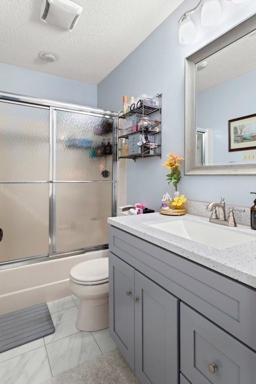 108 Abington Road, Unit 108 Danvers, MA 01923 - Photo 18 of 34 a bathroom with a granite countertop sink a toilet and a mirror
