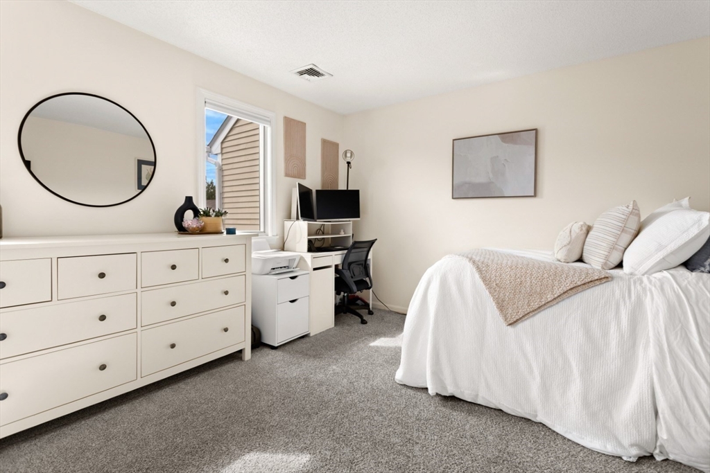 108 Abington Road, Unit 108 Danvers, MA 01923 - Photo 19 of 34 a bedroom with a bed and a dresser