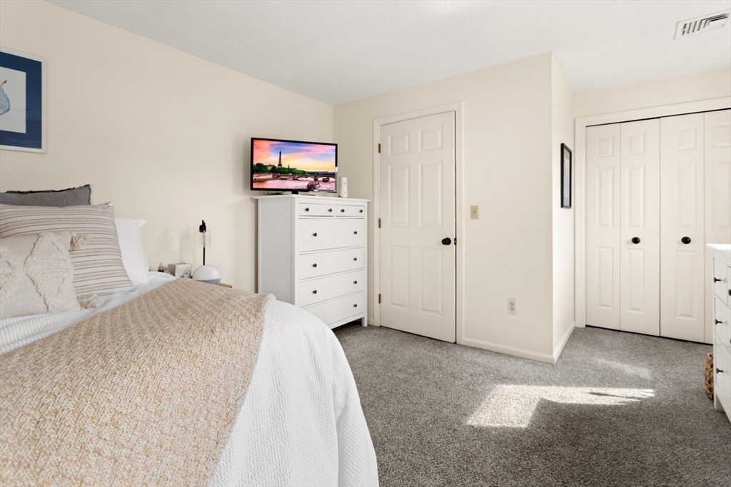 108 Abington Road, Unit 108 Danvers, MA 01923 - Photo 21 of 34 a bedroom with a bed and a furniture