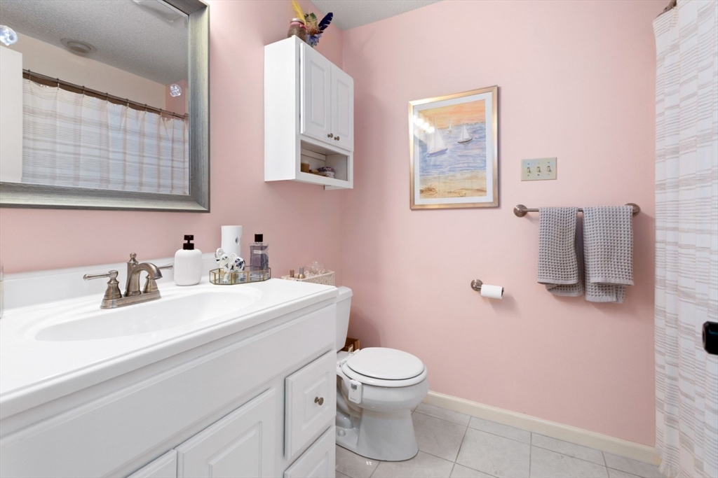 108 Abington Road, Unit 108 Danvers, MA 01923 - Photo 22 of 34 a bathroom with a toilet sink and mirror