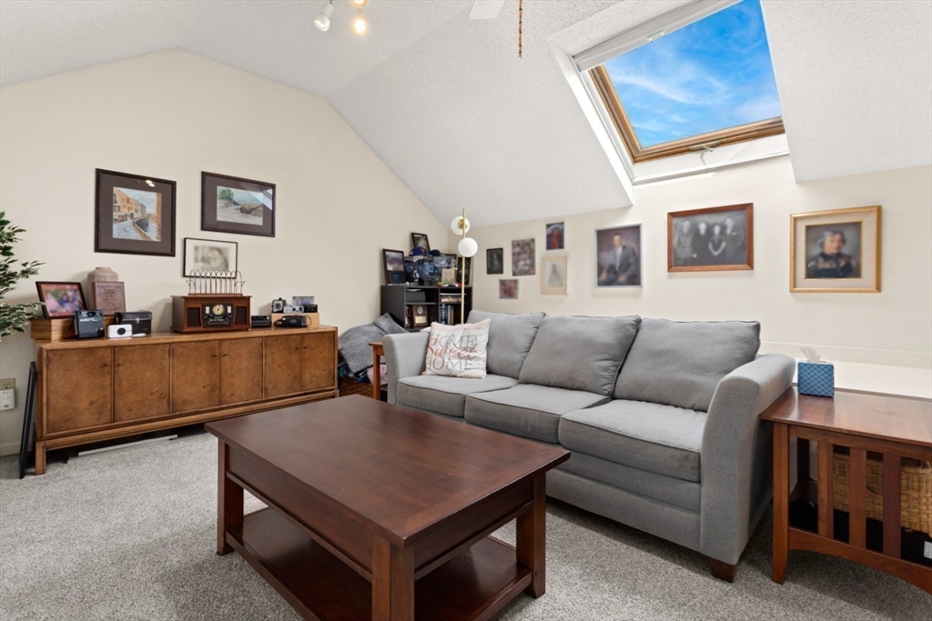 108 Abington Road, Unit 108 Danvers, MA 01923 - Photo 25 of 34 a living room with furniture and a flat screen tv