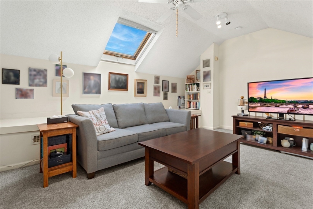 108 Abington Road, Unit 108 Danvers, MA 01923 - Photo 26 of 34 a living room with furniture and a flat screen tv